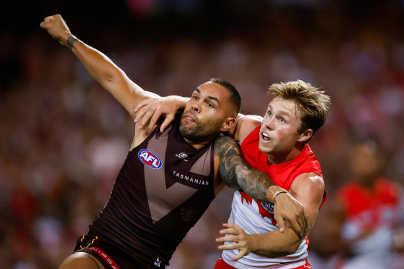 Jarman Impey of the Hawks and Braeden Campbell of the Swans compete for possession.