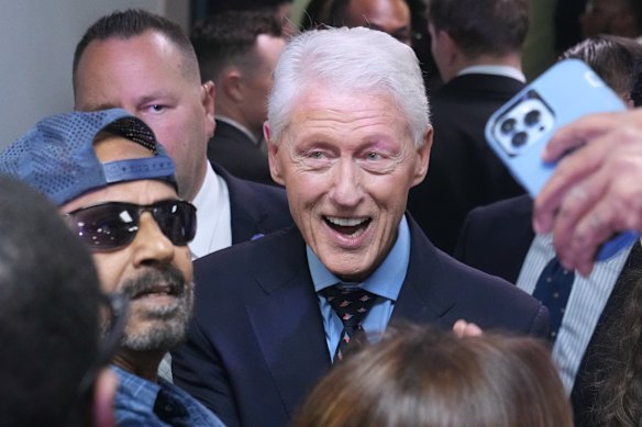 Former US president Bill Clinton takes a photo with a supporter of Florida Democratic candidate for governor, David Jolly. 