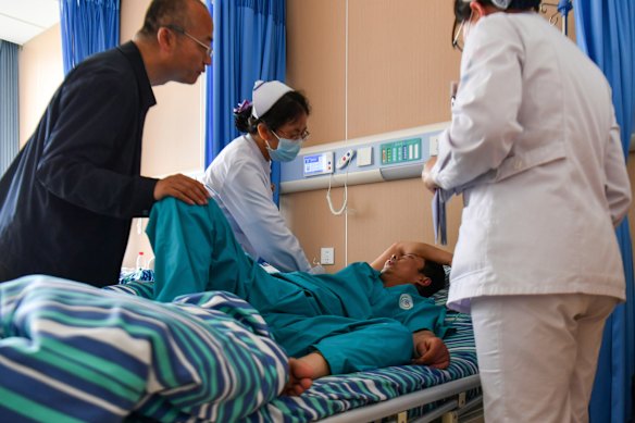Medical staff attend to an injured worker at a hospital in the aftermath of an explosion at Changzhi city’s Liushenyu coal mine.