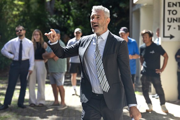 Auctioneer Brad Heffernan sells the Enmore apartment.