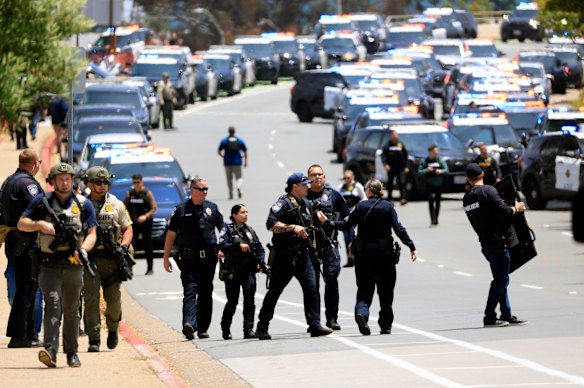  Law enforcement officers escort people away from the Islamic Centre of San Diego following the shooting.