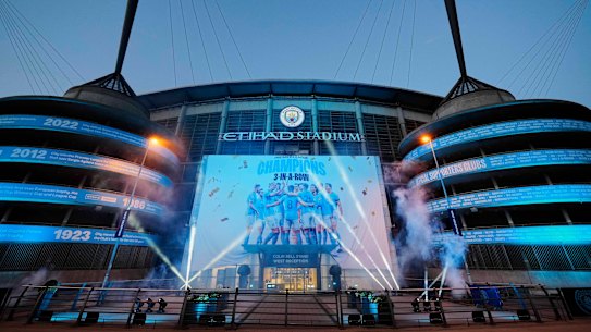 A banner celebrating their title win is illuminated outside Manchester City’s Etihad stadium in Manchester, England in 2023.