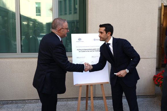 Prime Minister Anthony Albanese and Queensland Premier David Crisafulli sign a public school funding agreement at Parliament House in March. 