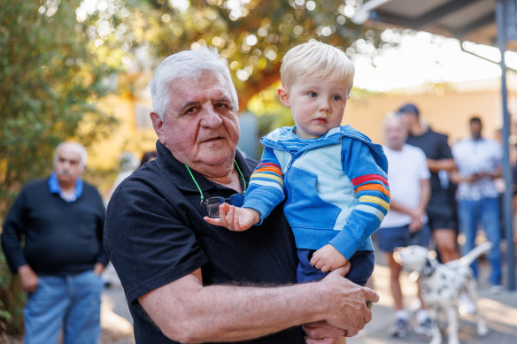 Mike Wallace lines up to vote in the referendum with his grandson, Lars Fossan, aged two.