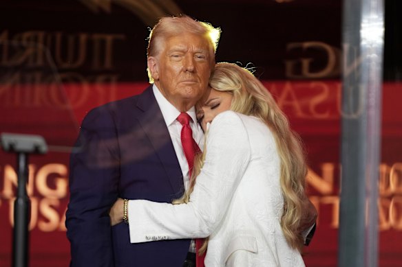 US President Donald Trump, left, hugs Erika at the memorial service.