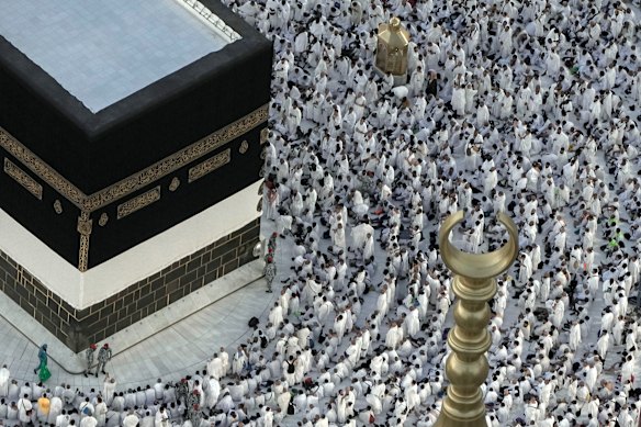 Muslim pilgrims pray in front of the Kaaba, the cubic building at the Grand Mosque, during the annual hajj pilgrimage, in Mecca, Saudi Arabia, in 2023.