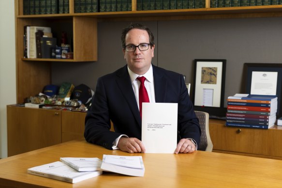 Veterans’ Affairs Minister Matt Keogh with the new simplified laws for veterans compensation compared with old laws.