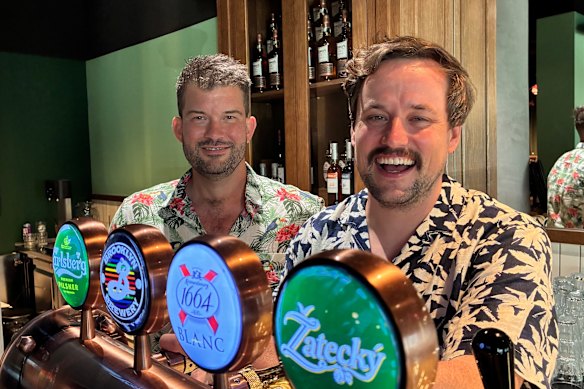 Rob Turner (left) and Justin Lestal at The Exchange Bar and Grill in Warsaw. The Australians are two of the bar’s co-owners.