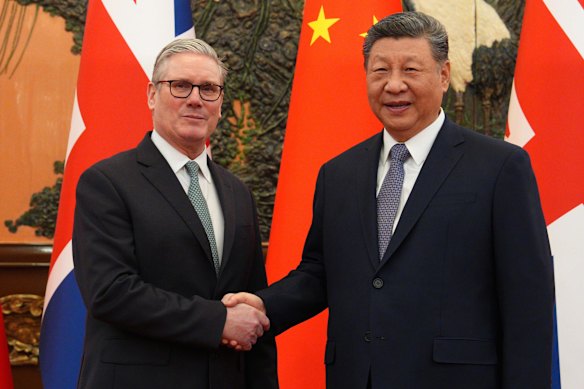 British Prime Minister Keir Starmer, left, shakes hands with Xi. 