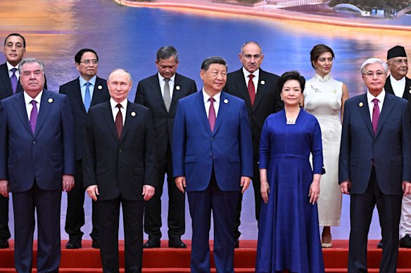 Russian President Vladimir Putin (centre left), Chinese President Xi Jinping (centre) and his wife Peng Liyuan (centre right), line up alongside other leaders at the Sunday welcoming ceremony for the Shanghai Co-operation Organisation summit.