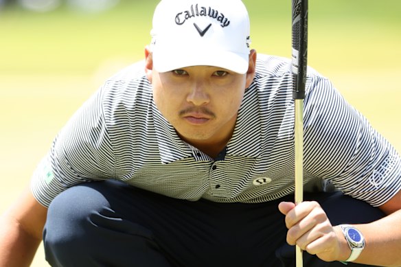 Min Woo Lee lines up a putt during the first round of the PGA Championship.