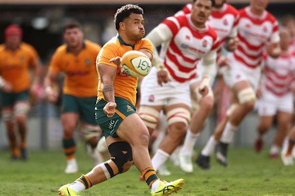 Hunter Paisami passes the ball against Japan