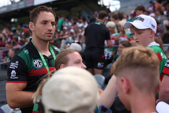 Cameron Murray signs autographs for fans during the game delay.