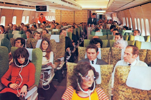 Passengers in economy class aboard a Qantas Boeing 747 jet in the 1970s.