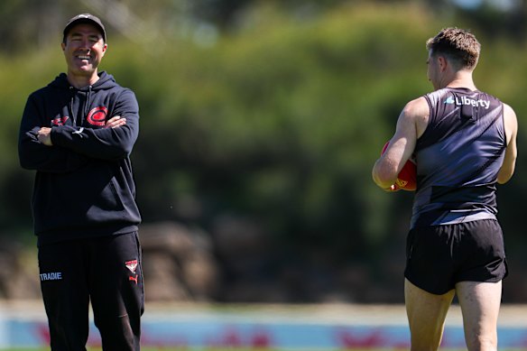 Brad Scott (left) and Merrett share a laugh at the star onballer’s first day back at pre-season training since his failed trade request.