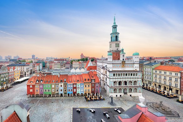 A view across the rooftops of the Polish city of Poznan showing its central square and town hall.