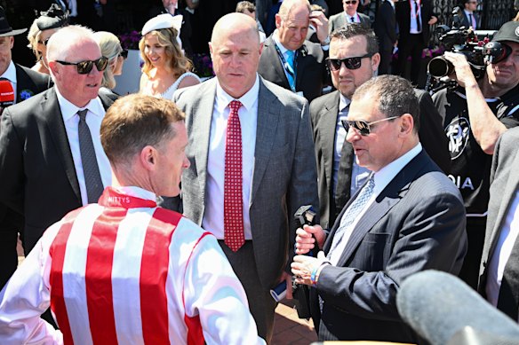 Owner Jonathan Munz, right, speaks to jockey Mark Zahra after winning the 2025 Wakeful Stakes with Getta Good Feeling.