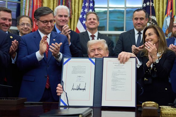 US President Donald Trump displays the signed funding bill to reopen the government.