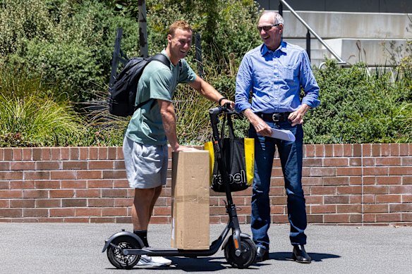 Daly Cherry-Evans parks his scooter while talking to Wayne Bennett on Driver Avenue last year.