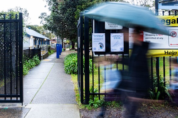 Parents drop children off at Lane Cove West Public School, where Sydney childcare worker David James allegedly filmed abuse of children while working at the Helping Hands outside school hours care centre. 