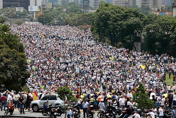 Anti-government protesters march along a highway in Caracas in 2017. 