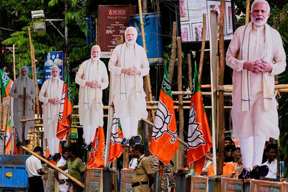 Cardboard cutouts of Modi line a roadside in Kolkata.
