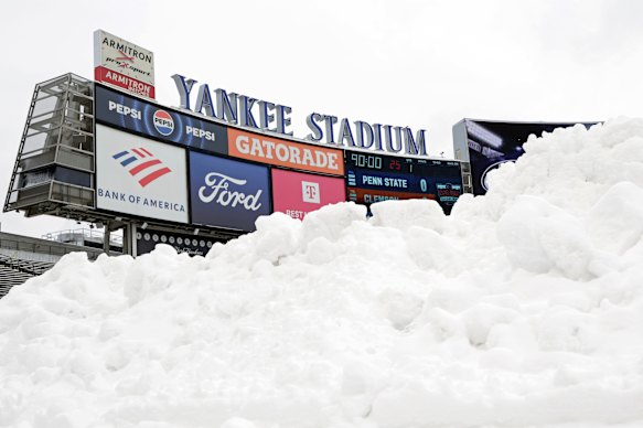 Snow piled up on the field at Yankee Stadium on Saturday.