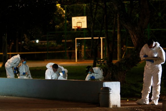 Investigators inspect the scene where Miguel Uribe Turbay was shot in a Bogota park.