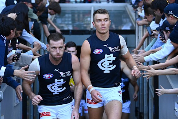 Co-captains Sam Docherty and Patrick Cripps lead their team out on to the field in 2021.