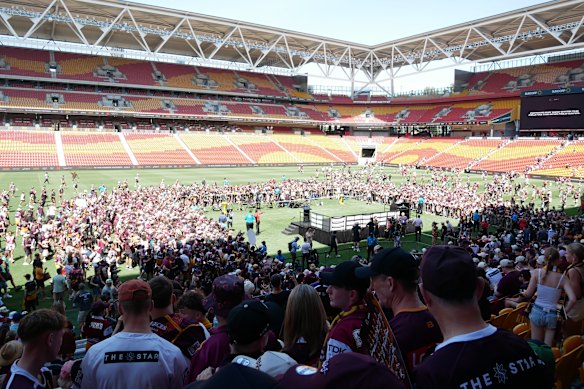 Fans flood the field at Suncorp Stadium a day after the 2025 NRL and NRLW grand finals before the teams arrived.