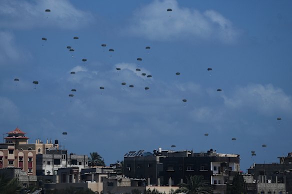 Humanitarian aid is dropped over Nuseirat in the central Gaza Strip on Sunday.