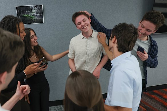 Kew High School dux Toby Jenkin (centre) is congratulated on his 99.9 ATAR score by his brother Aidan and other members of the four sets of twins graduating from Kew this year.