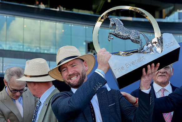 Tempted’s trainer Ciaron Maher lifts the Everest trophy.