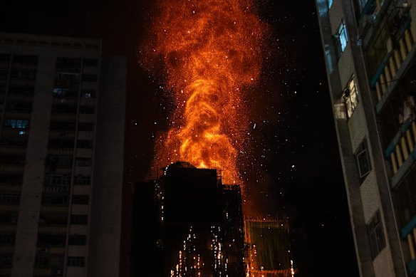 Flames engulf a building after a fire broke out at Wang Fuk Court,