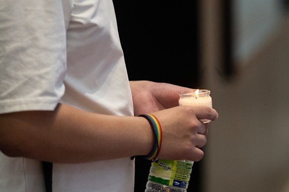 A man holds a candle on the street in Causeway Bay on Thursday.