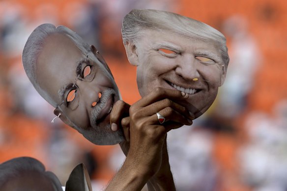 Indians hold masks of US President Donald Trump and Indian Prime Minister Narendra Modi at the “Namaste Trump” event in 2020.