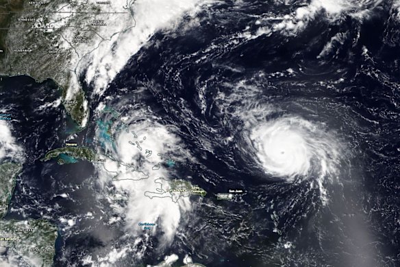A satellite image of Tropical Depression Nine over Jamaica and Cuba, and Hurricane Humberto to the north-east of the Virgin Islands. 