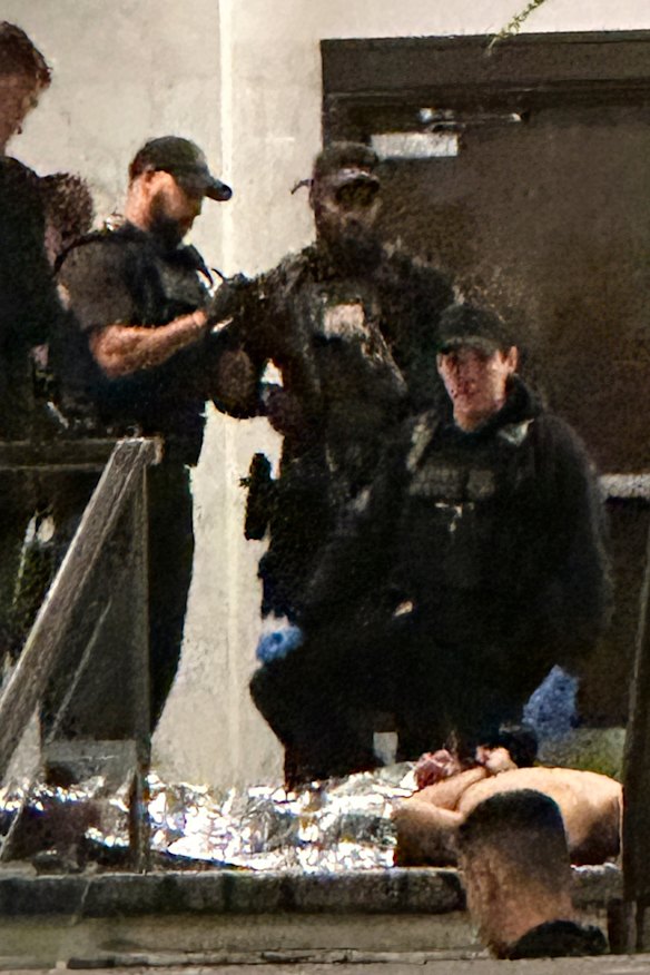 Suspect Cole Tomas Allen lies on the ground after being overpowered by law enforcement.