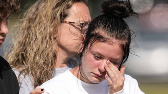 A student weeps at a makeshift memorial after a shooting Wednesday at Apalachee High School in Winder, Georgia.