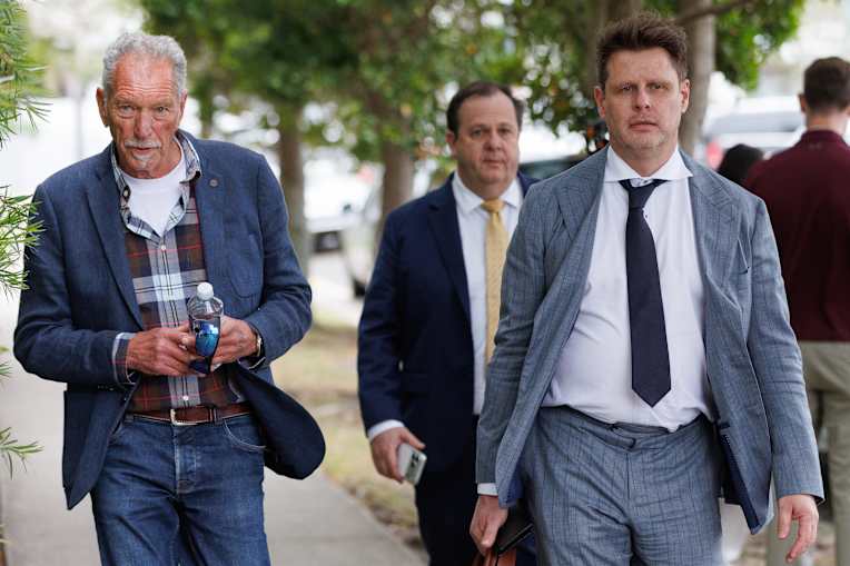 The father of Sam Wood, Andrew Wood (left), barrister David Cole (back right) and lawyer Mathew Cuskelly (front right) head i