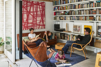 The living room may be small, but Ruth is more than happy with it. “The reality is that that’s all you need,” she says. The large pink artwork is by Brett McMahon.