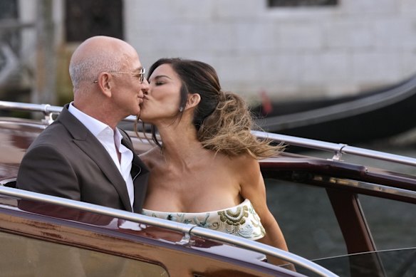 Bezos and Sánchez are pictured here sharing a kiss as they leave their hotel in Venice for a pre-wedding reception.
