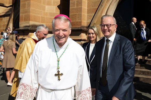 Prime Minister Anthony Albanese and fiancee Jodie Haydon (rear) with Sydney Archbishop Anthony Fisher on Sunday.