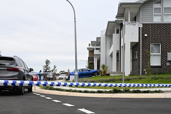 Police at the crime scene of a fatal stabbing on Driftway Drive, corner of Cherribit Street, Pemulwuy.