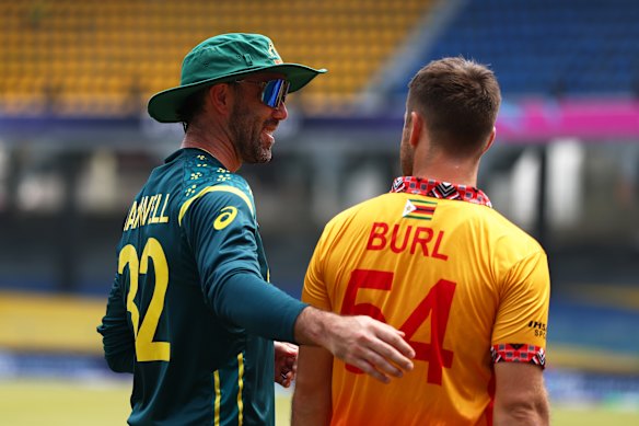 Glenn Maxwell of Australia and Ryan Burl of Zimbabwe interact.