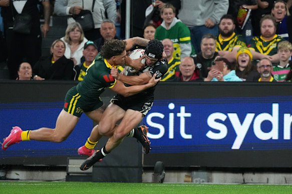 Australia’s Reece Walsh, left, tackles New Zealand’s Kalyn Ponga.