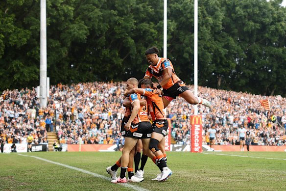 Samuela Fainu of the Wests Tigers celebrates a try.