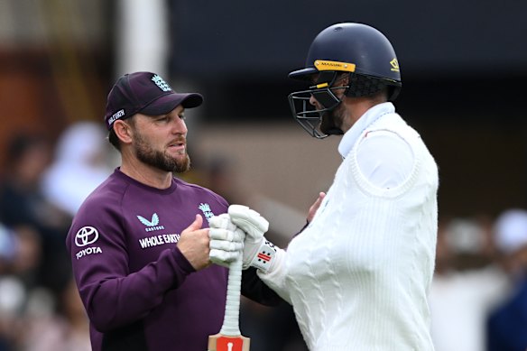 Brendon McCullum with Chris Woakes.