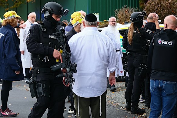 The attack happened when Rabbi Walker was leading the Yom Kippur service. Later he comforted his congregation, blood visible on his white robe.