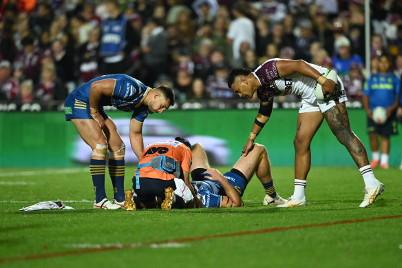 Shaun Lane receives attraction    aft  a tackle from Haumole Olakau’atu and Daly Cherry-Evans.